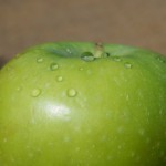 close-up of green apple with water drops