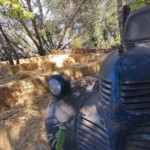 Front of truck in front of hay maze